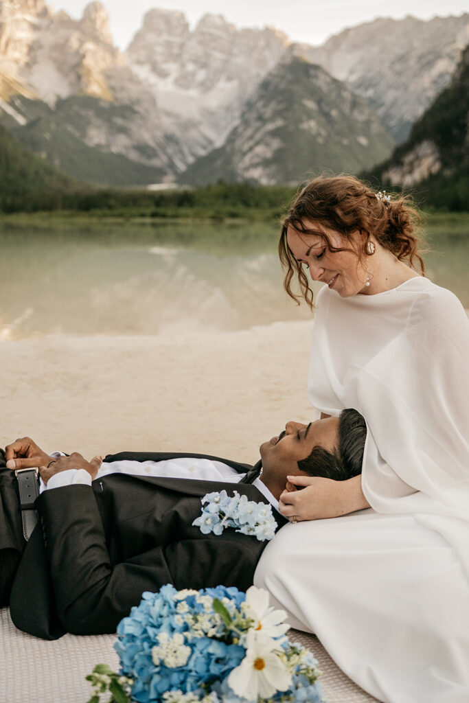 Bride and groom by a mountain lake