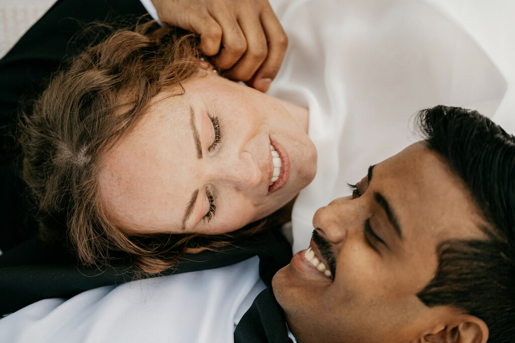 Couple smiling at each other closely.