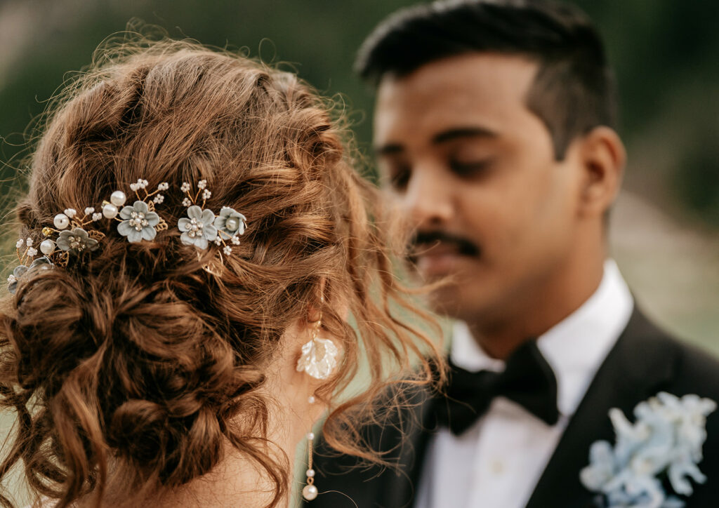 Bride with floral hair accessory and groom, wedding moment.