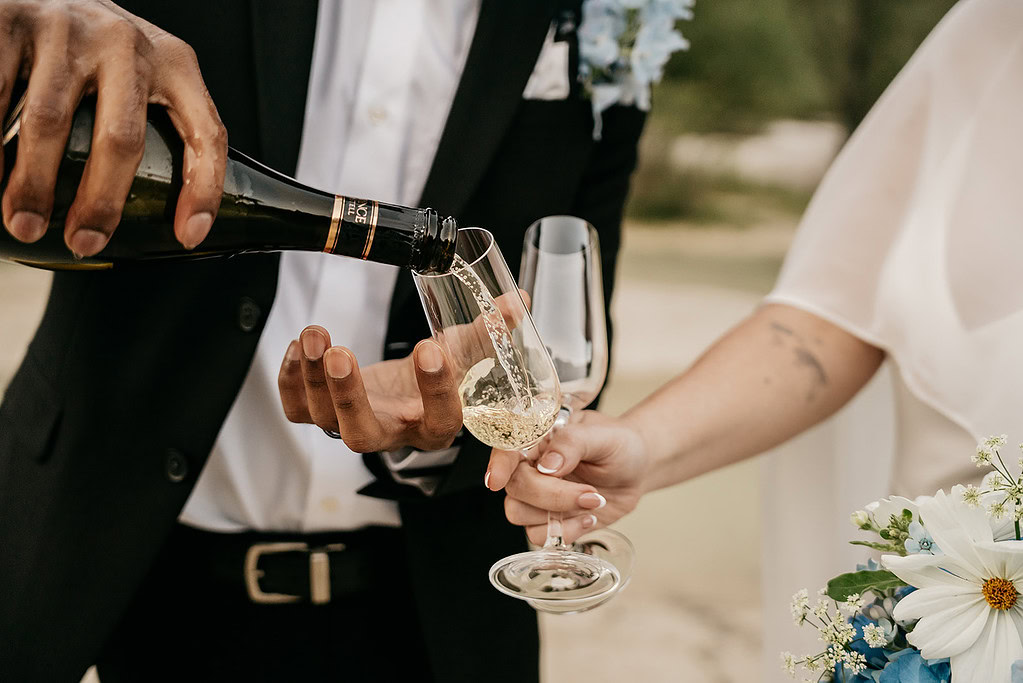 Pouring champagne at an outdoor celebration