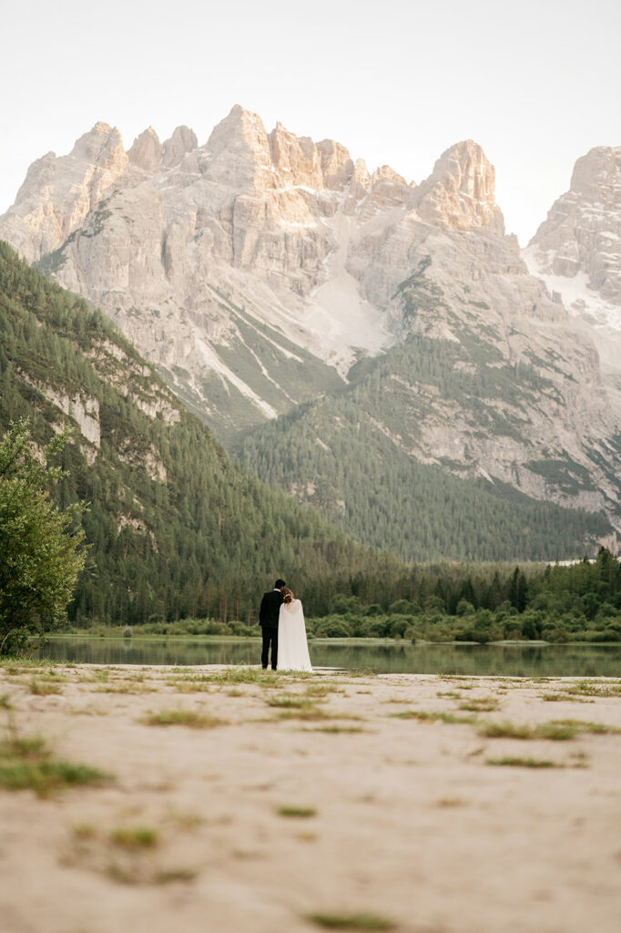 Couple embracing by mountain lake