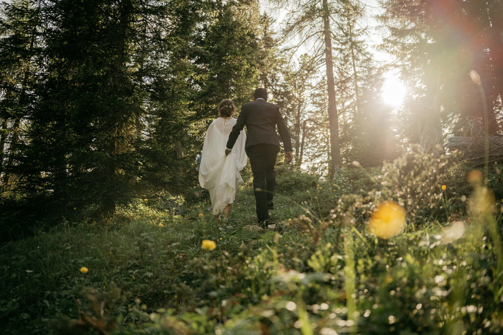 Couple walking in a forest, sunlight filtering through