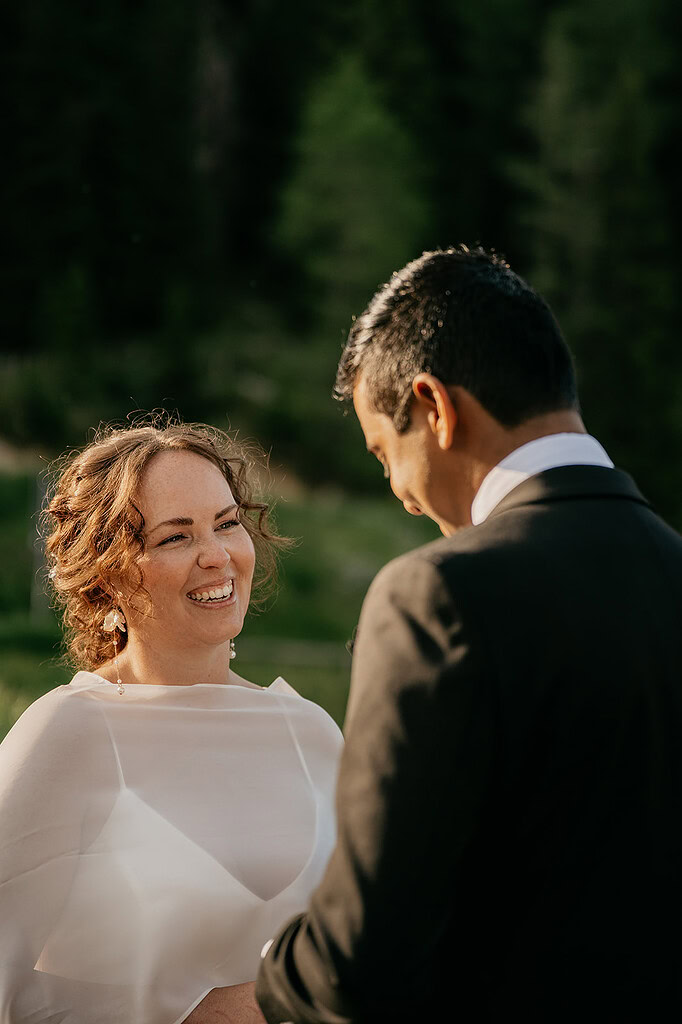 Smiling couple during outdoor wedding ceremony