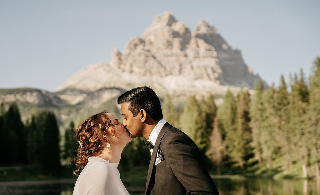 Couple kissing near mountain landscape