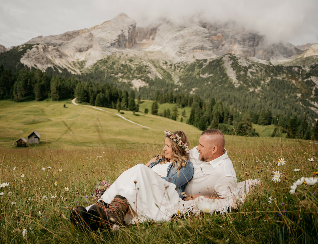 Couple relaxing in scenic mountain meadow