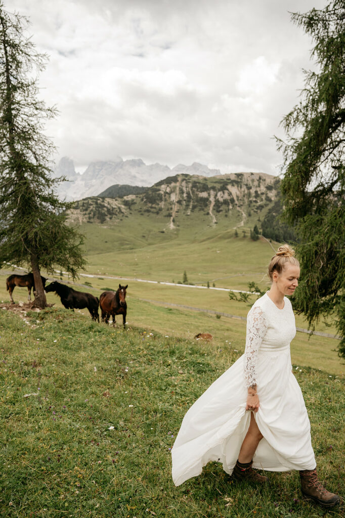 Woman in white dress walking on mountain meadow