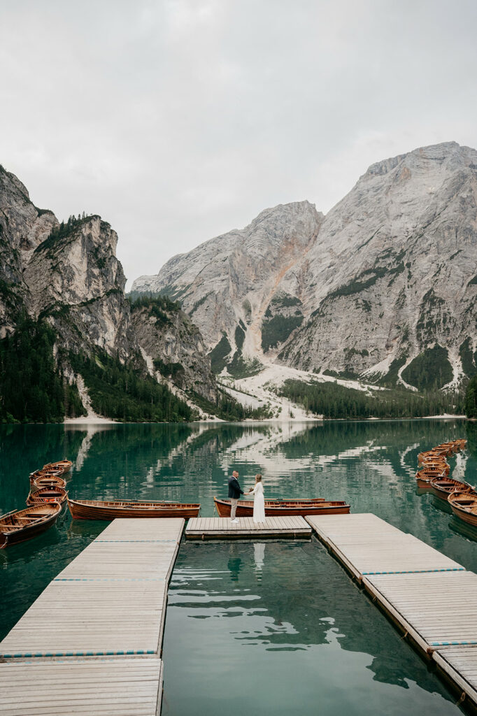 Couple standing on dock in mountain lake