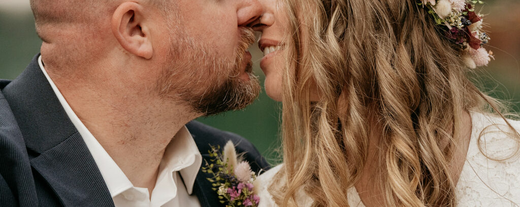 Close-up of couple kissing at wedding.