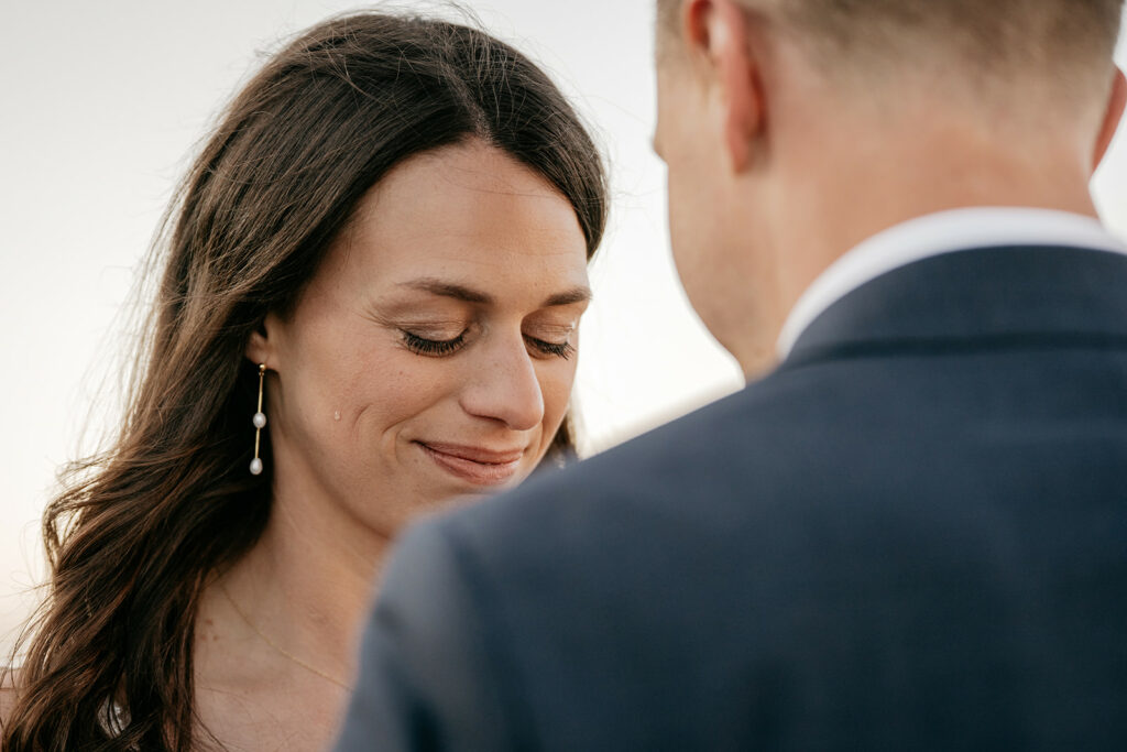 Woman smiling softly during an emotional moment.