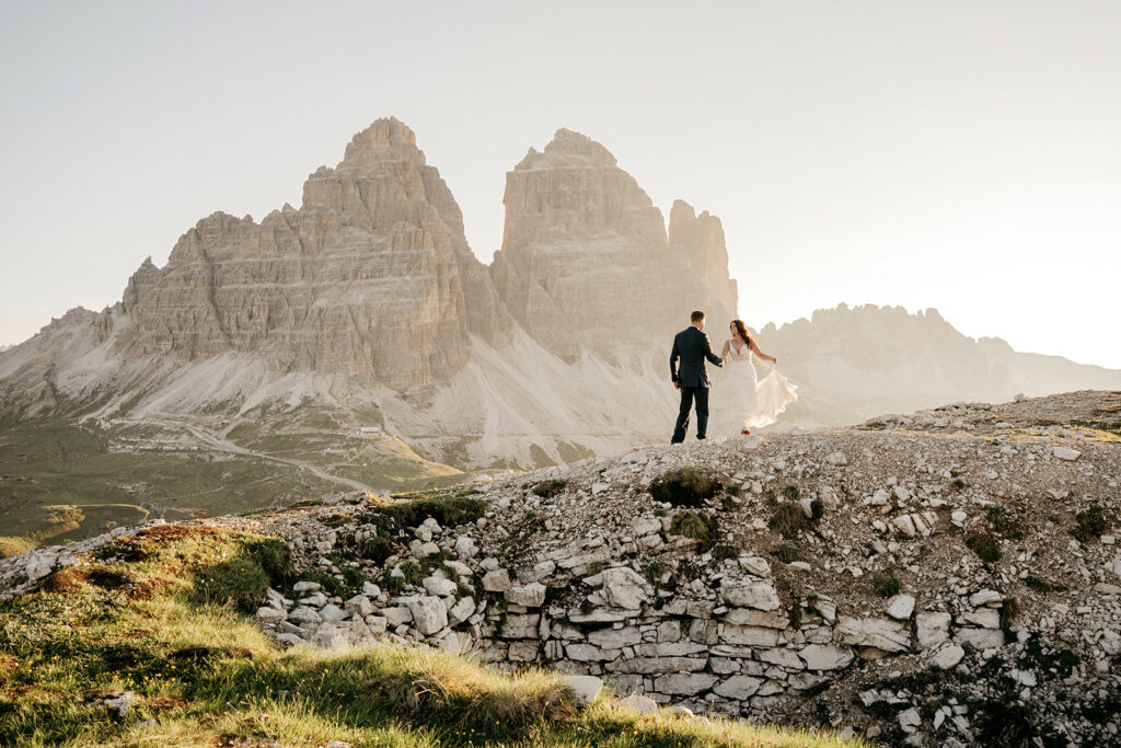 Couple in wedding attire on mountainous landscape