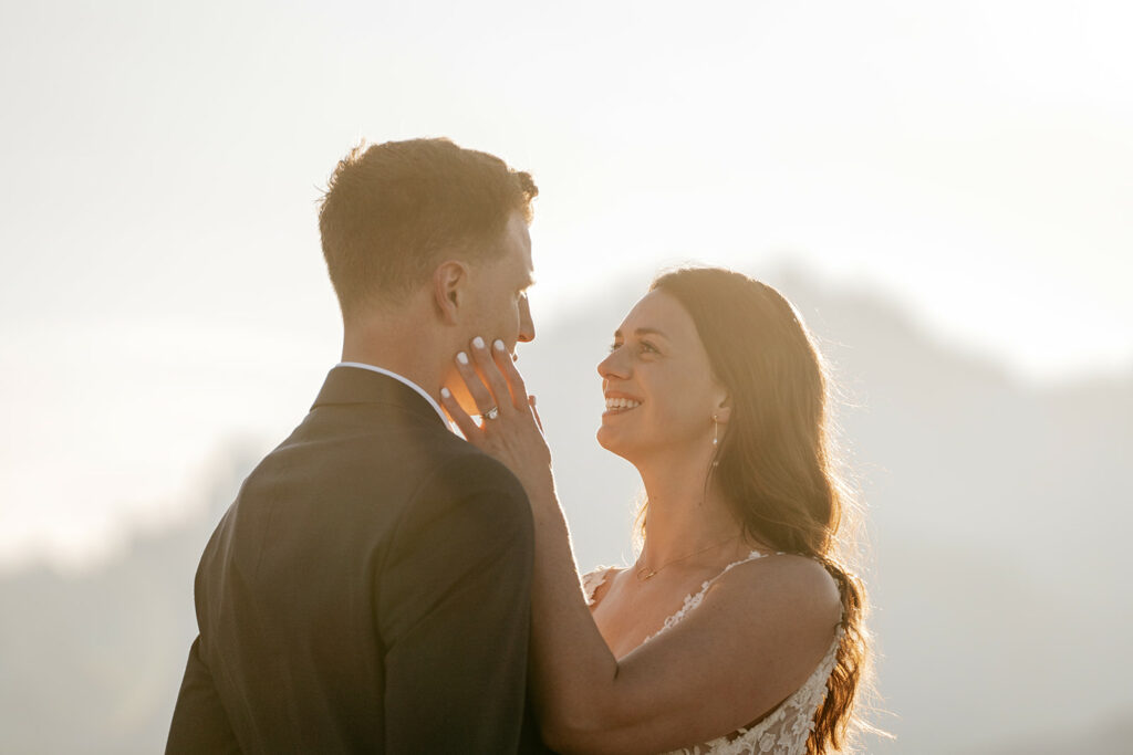 Bride and groom sharing a loving moment outdoors.