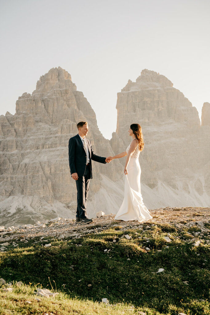 Couple holding hands with mountain backdrop