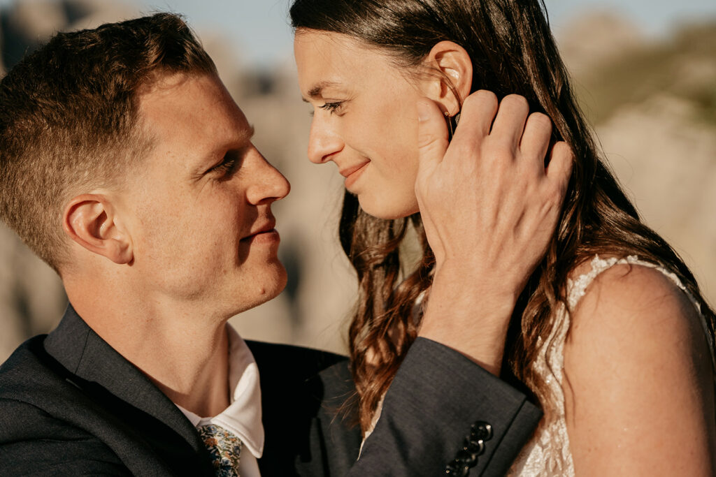 Couple embracing outdoors during sunset.
