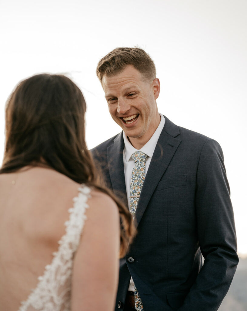 Smiling man in suit during wedding ceremony