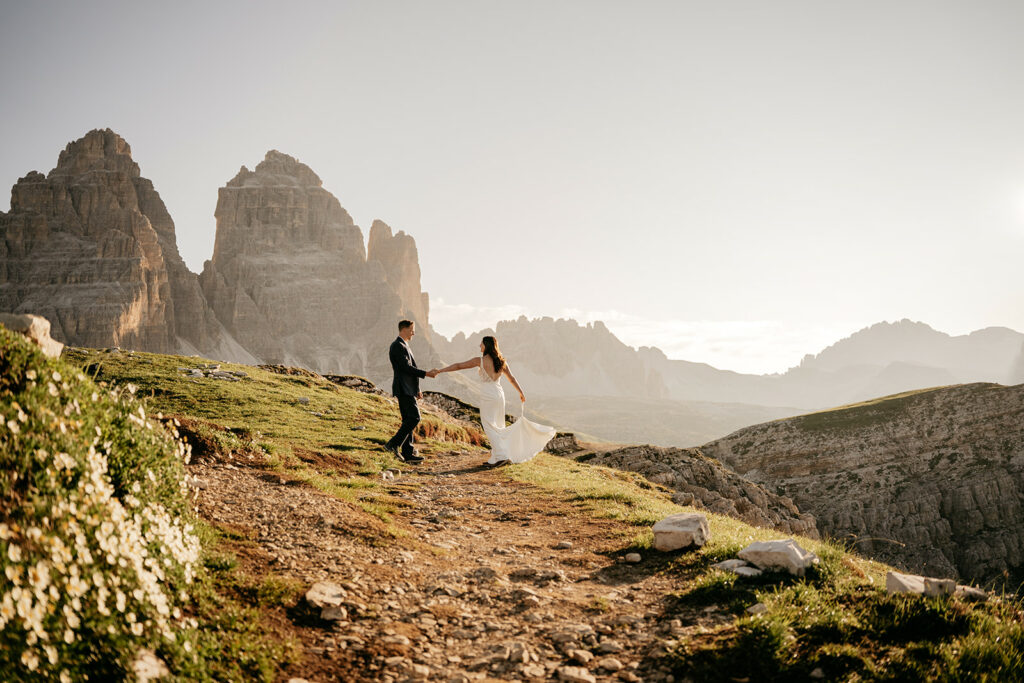 Couple dancing on mountain path during sunset