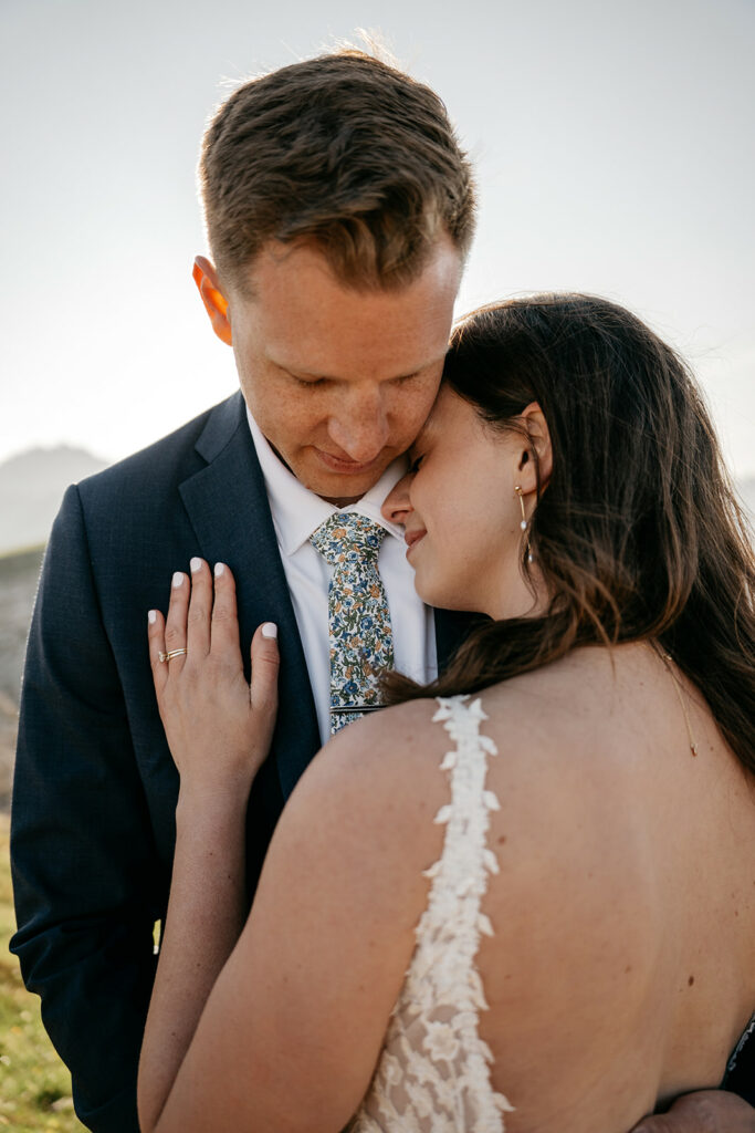 Couple embracing on wedding day outdoors.