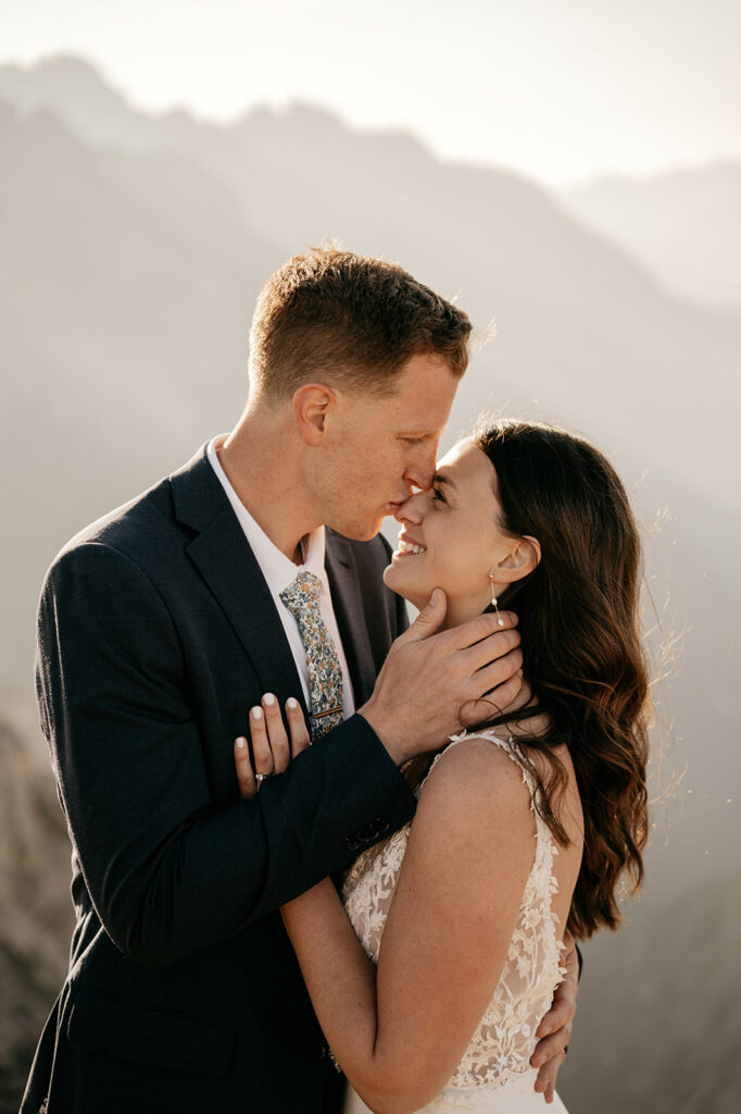Couple embracing in scenic mountain view.