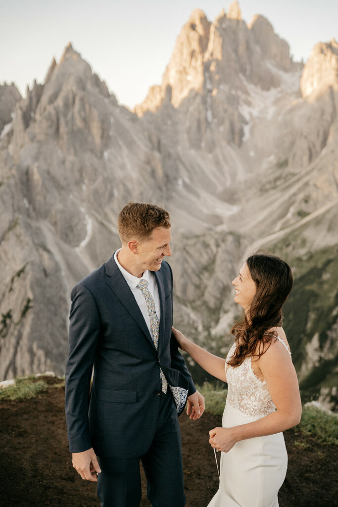 Couple smiling with mountain backdrop at wedding