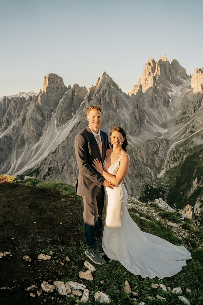 Couple posing in mountains at sunset.