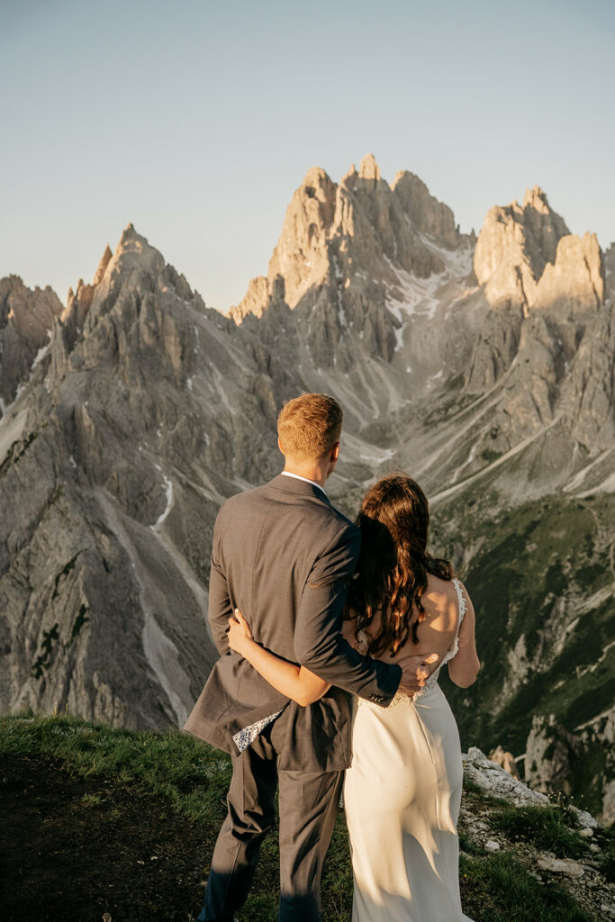 Couple embracing with mountain view at sunset.
