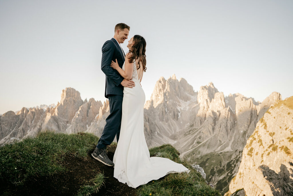 Couple embracing on mountain during sunset