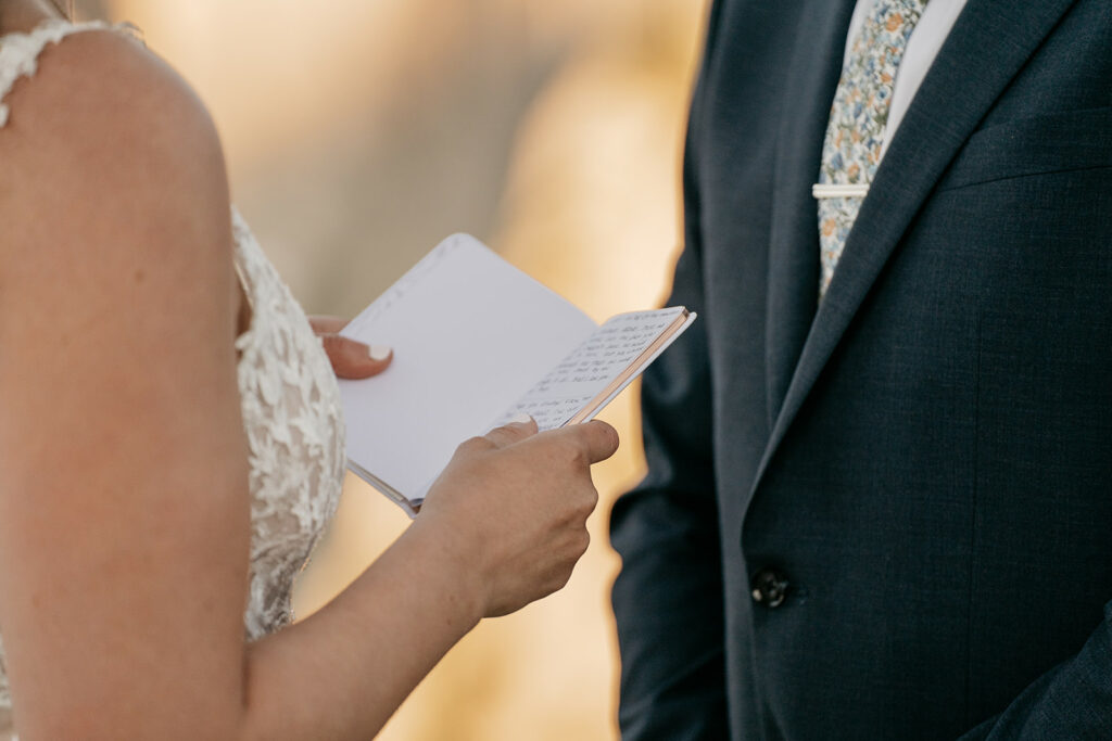 Wedding vows exchanged by couple in formal attire.