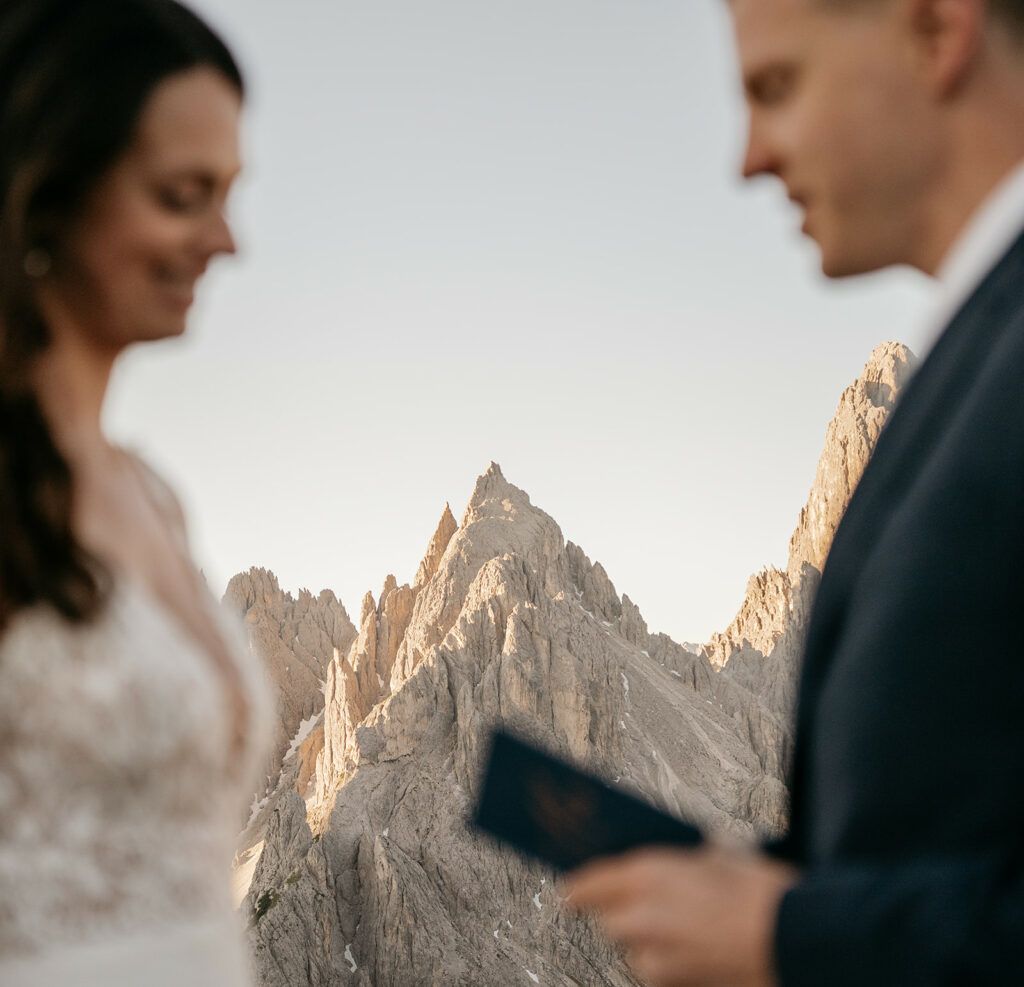 Couple exchanging vows in mountain landscape