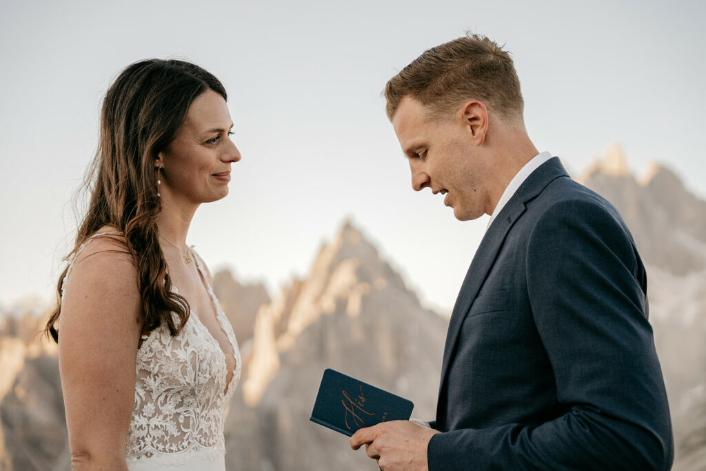Couple exchanging vows at mountain wedding ceremony.