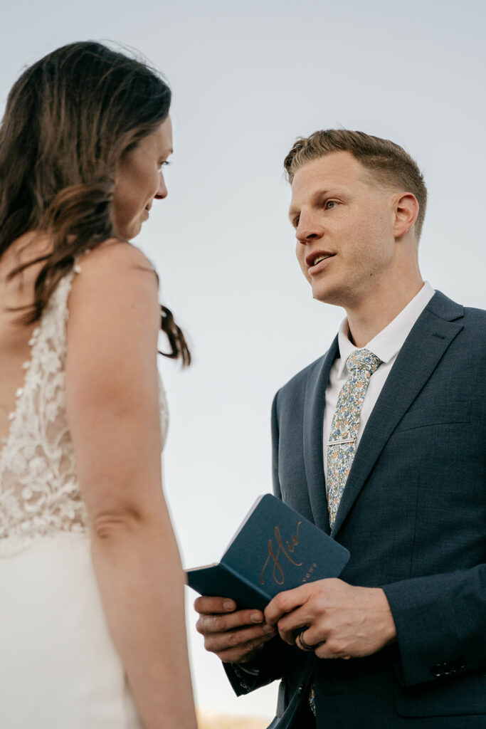 Couple exchanging wedding vows outdoors.