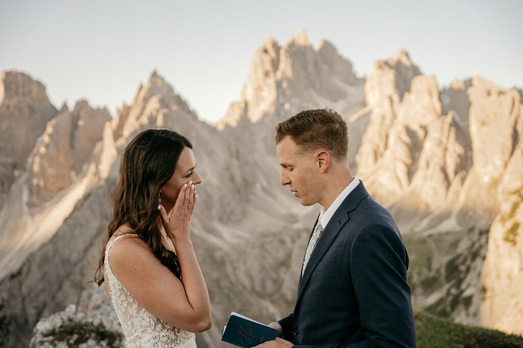 Couple exchanging vows in mountain setting