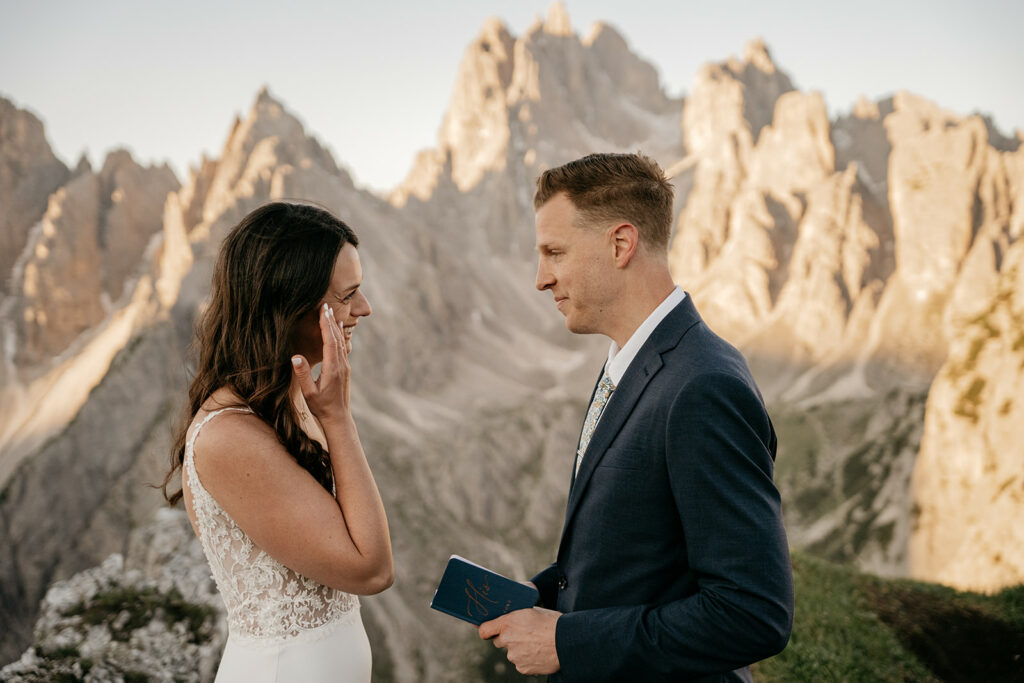 Couple exchanging vows with mountain backdrop