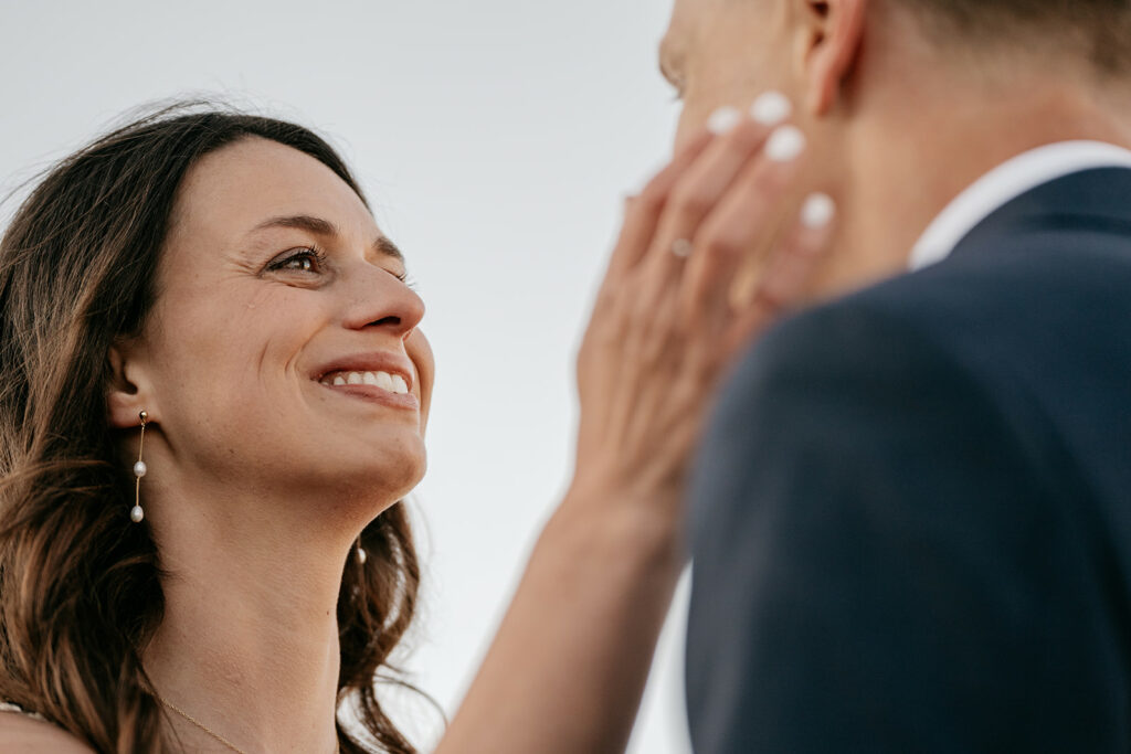 Woman smiling at another person at sunset.