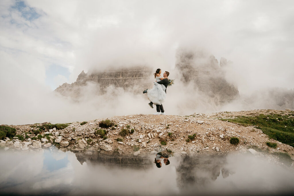 Couple embracing on foggy mountain landscape