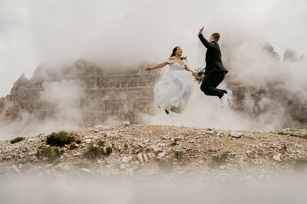 Couple jumping joyfully in mountainous landscape