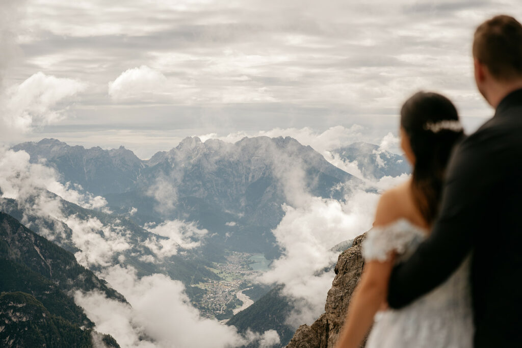 Couple enjoying scenic mountain view with clouds
