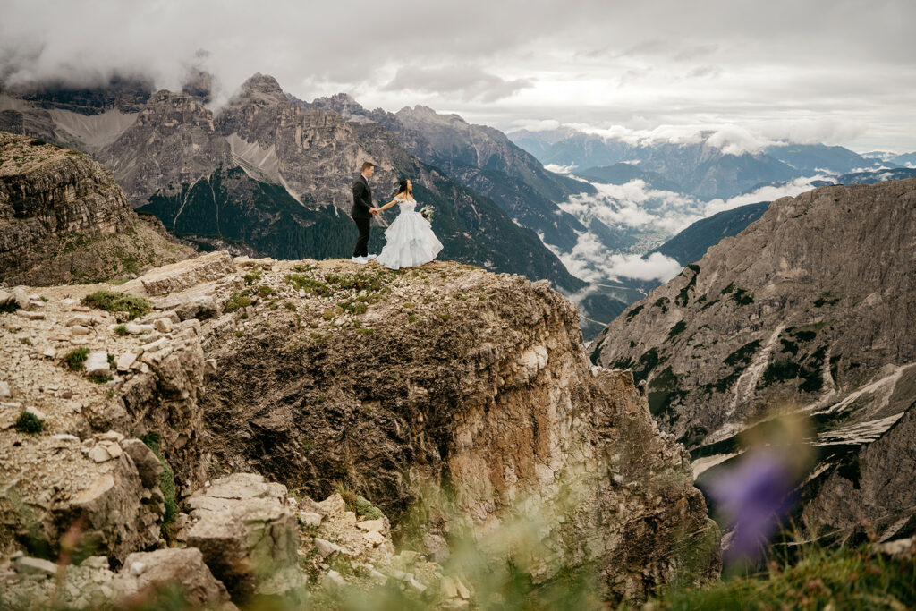 Couple on mountain cliff with scenic view