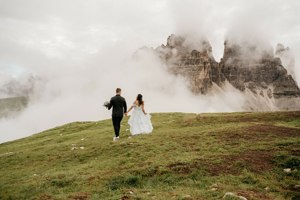 Couple walking on misty mountain landscape
