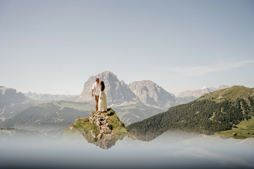 Couple on mountain peak with stunning views.