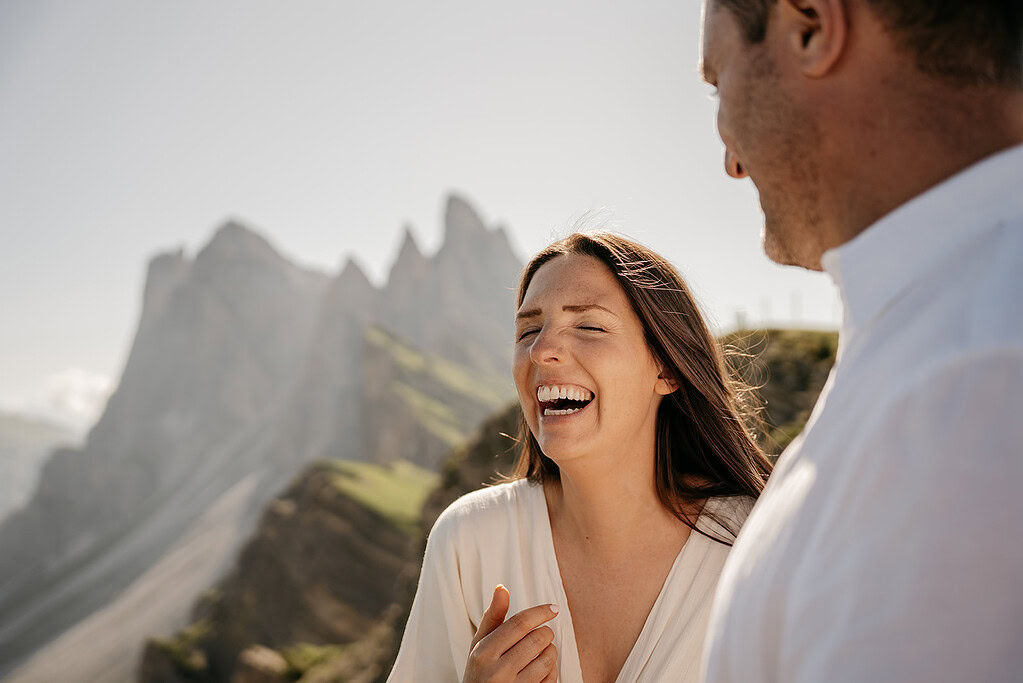 Couple laughing together in mountain scenery