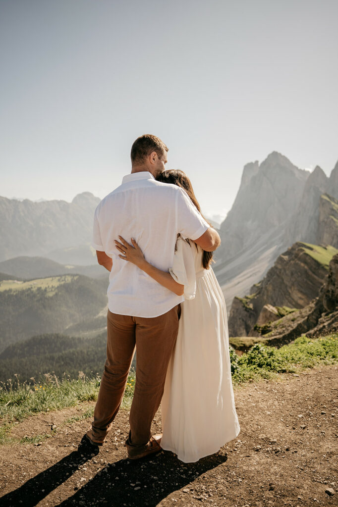 Couple embracing with stunning mountain view.