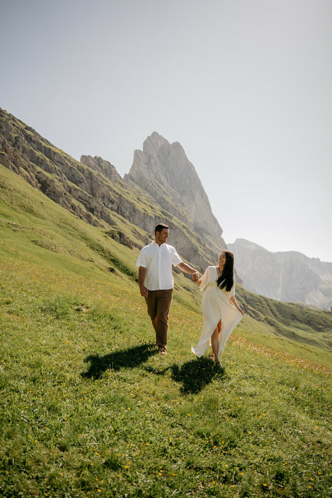 Couple walking on sunny mountain meadow