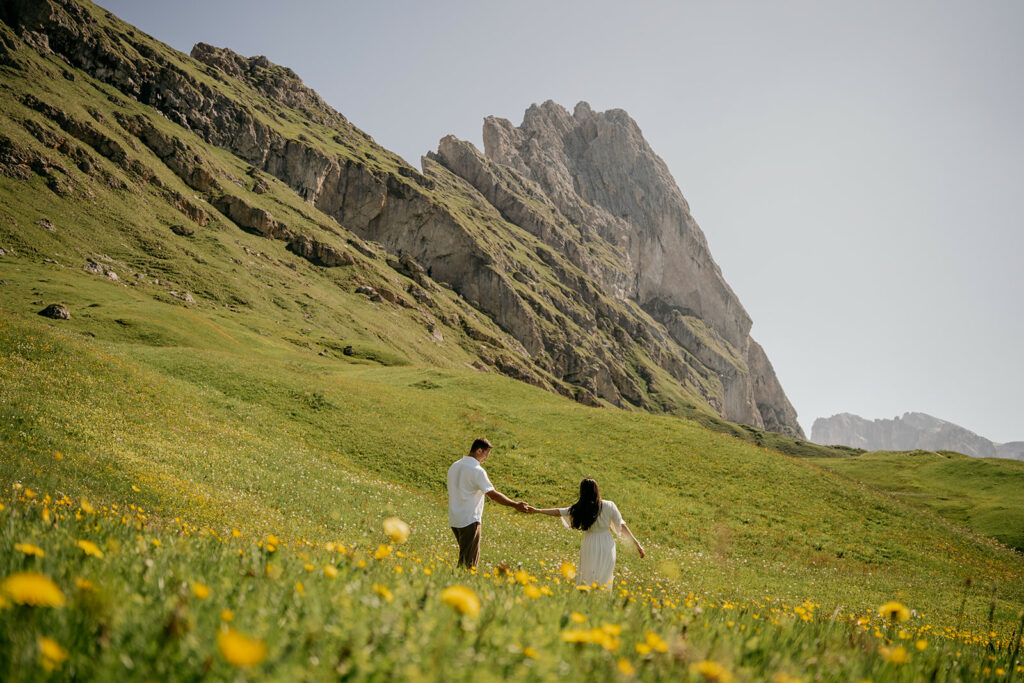 Couple holding hands in mountain meadow