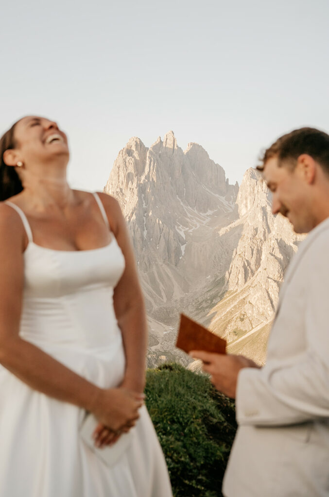 Couple laughing during mountain wedding ceremony.