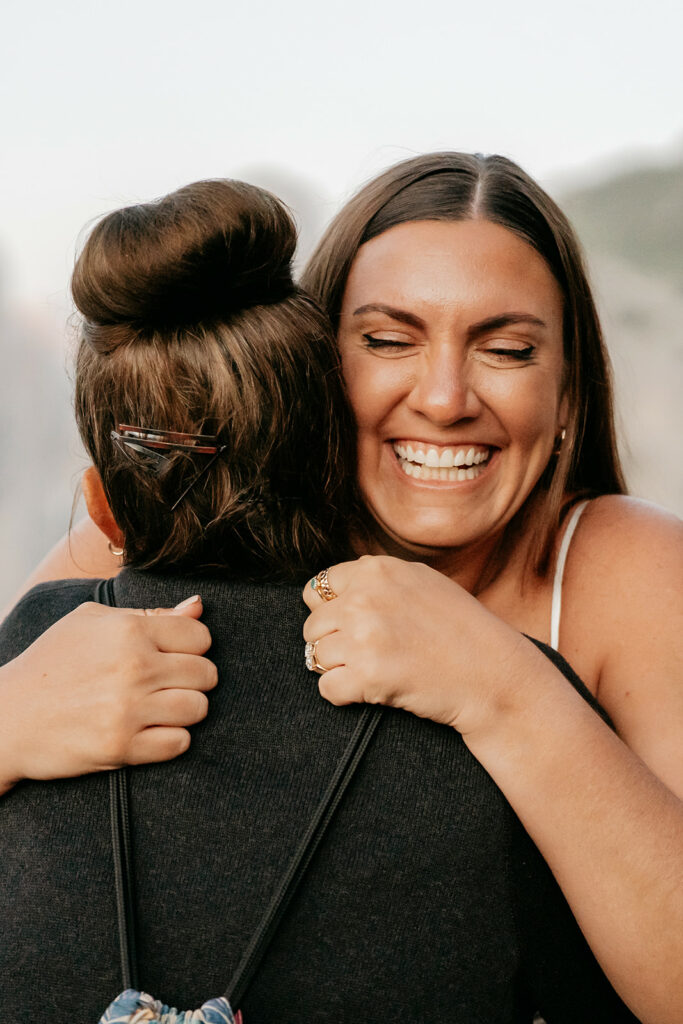 Two people hugging and smiling joyfully.