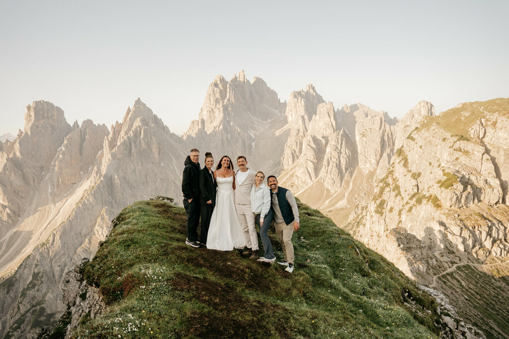 Group on mountain with scenic rocky peaks.