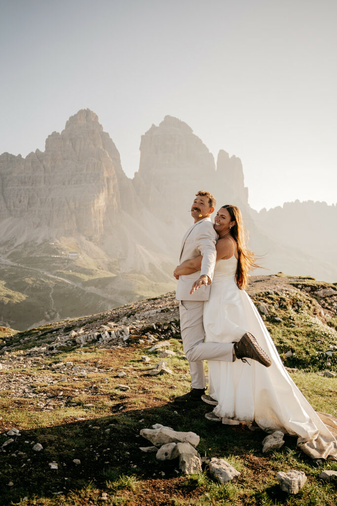 Couple embracing in mountainous landscape.