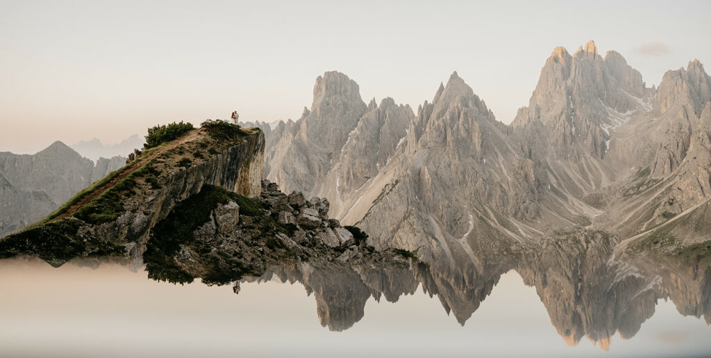 Majestic mountains reflected in calm water.