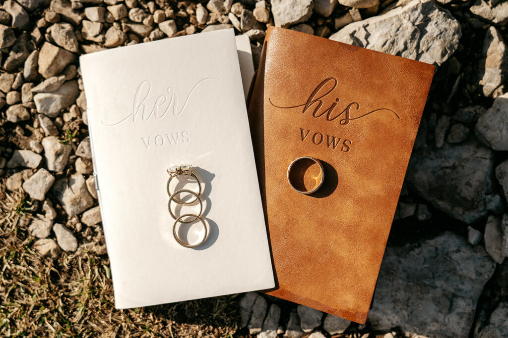 His and Her vow books with rings on rocks