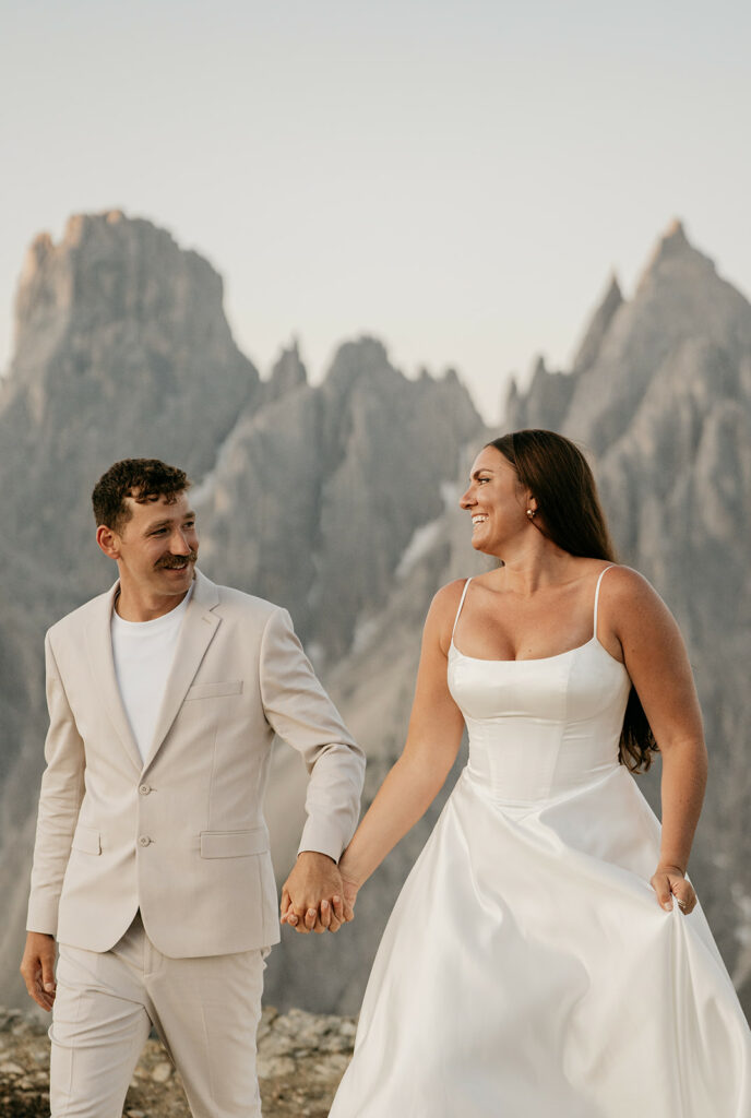 Bride and groom smiling in mountain landscape