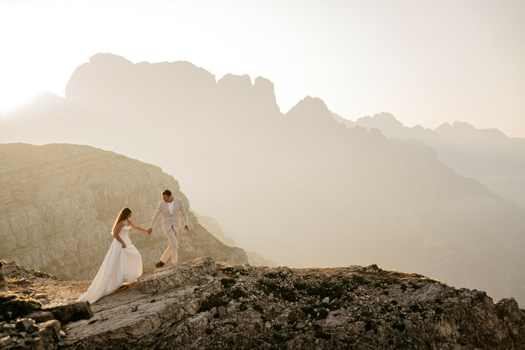 Couple walking on mountain landscape during sunset